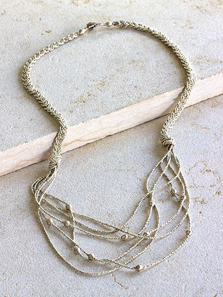 silver hued-silver-beads-handmade-bullet casings-artillery shells-recycled-metals-ethiopia-artisansentoto mountain-women-beautiful-jewellery-fair trade-thread